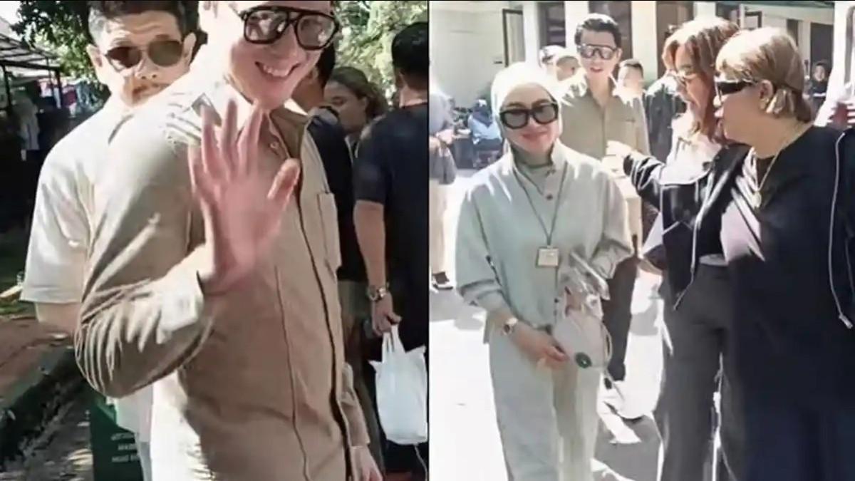Syahrini tampil dengan setelan berwarna hijau tosca dan berjalan di depan Reino Barack yang mengenakan kemeja hijau army.