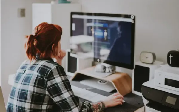 A Women Is Working In Front of There Laptop