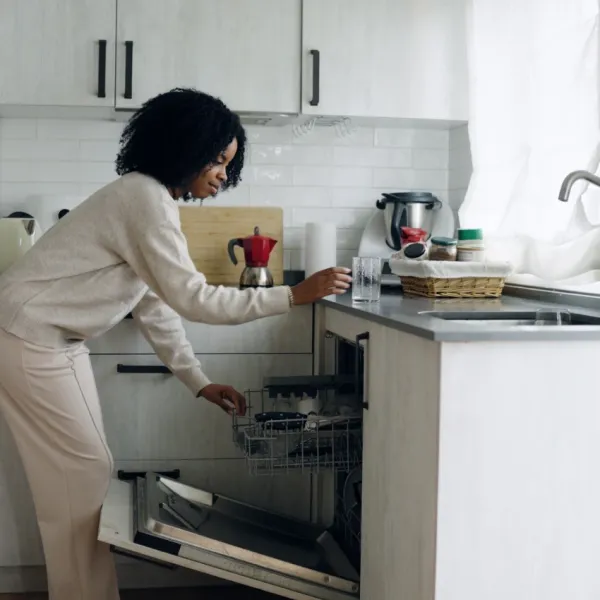 woman cleaning kitchen loading dishwasher working clockwise around the room