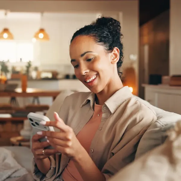 woman smiling reading text from reliable friend