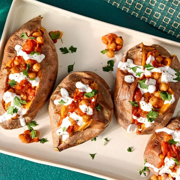 A recipe image of Stuffed Sweet Potato with Chickpeas & Tomatoes. Credit: Photographer: Jen Causey.