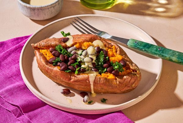 Stuffed Sweet Potato with Hummus Dressing, low angle on a plate Credit: Ali Redmond
