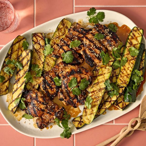 A recipe image of Grilled Honey-Garlic Chicken Thighs with Zucchini. Credit: Photographer: Jen Causey.