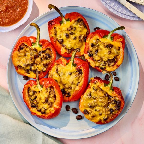 a recipe photo of 5-Ingredient Taco Stuffed Peppers Credit: Photographer: Robby Lozano, Food Stylist: Jennifer Wendorf, Prop Styling: Josh Hoggle.