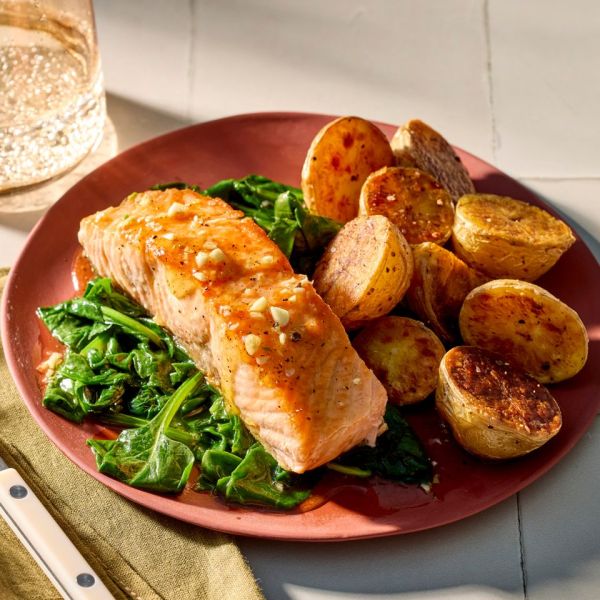 a recipe photo of Seared Honey Salmon with Potatoes and Spinach Credit: Photographer: Jake Sternquist, Food Stylist: Sammy Mila, Prop Stylist: Gabriel Greco.