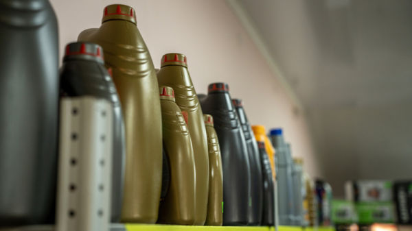 Bottles of automotive fluids organized on shelf
