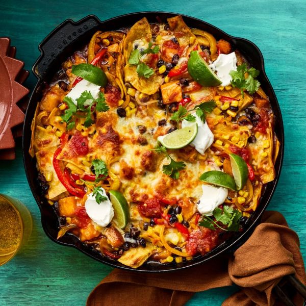 Recipe image of Butternut Squash & Black Bean Enchilada Skillet. Credit: Photographer Victor Protasio, Food Stylist Margaret Dickey, Prop Stylist Josh Hoggle.