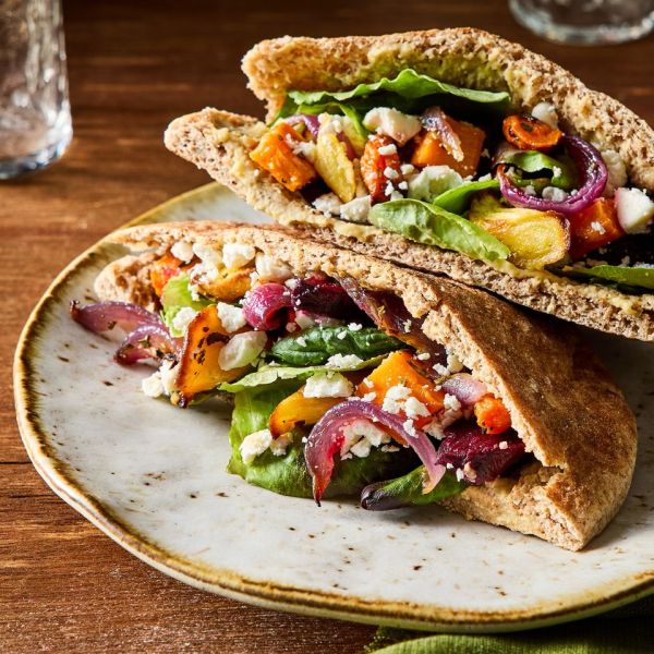 A recipe image of Roasted Veggie & Hummus Pita Pockets. Credit: Photographer: Kelsey Hansen, Prop Stylist Natalie Ghazali, Food Stylist: Shannon Goforth.